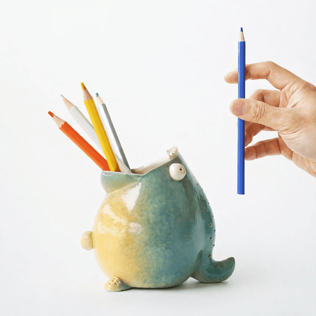 Ceramic pen holder for desk in clean white background 