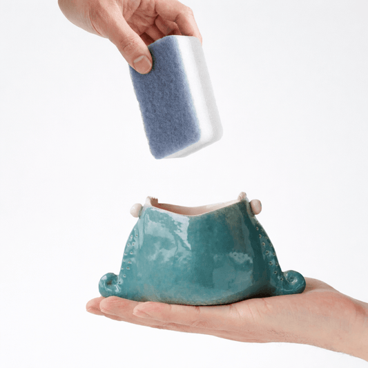 Ceramic sponge holder for sink in clean white background